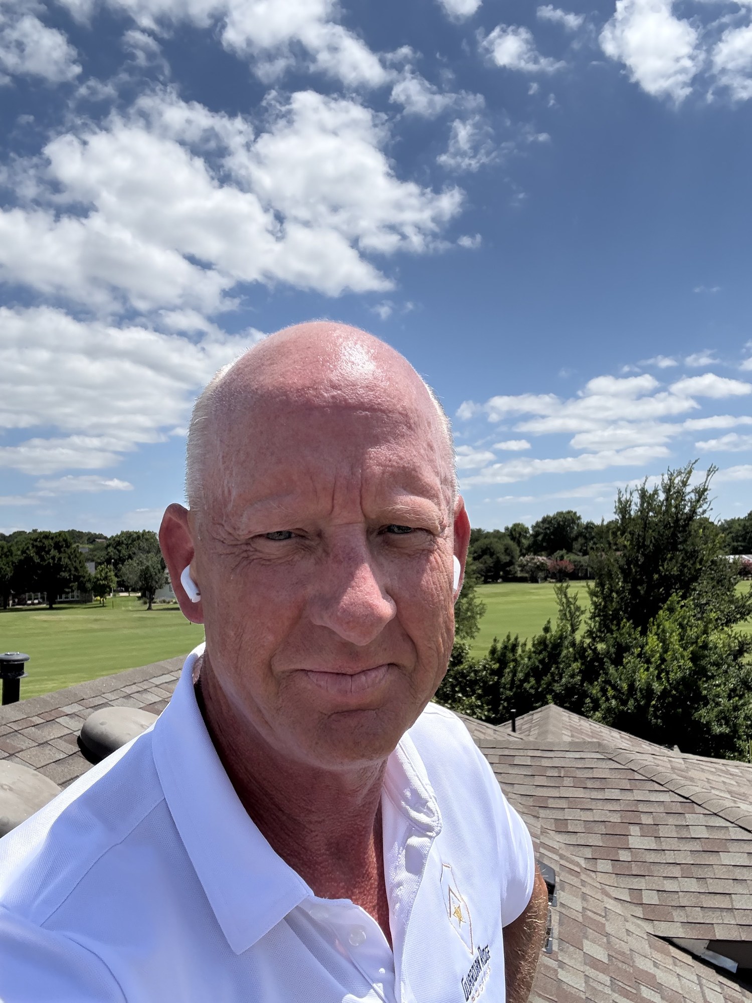 Guardian Ridge Roofing team member on site at a residential roofing project under a clear sky