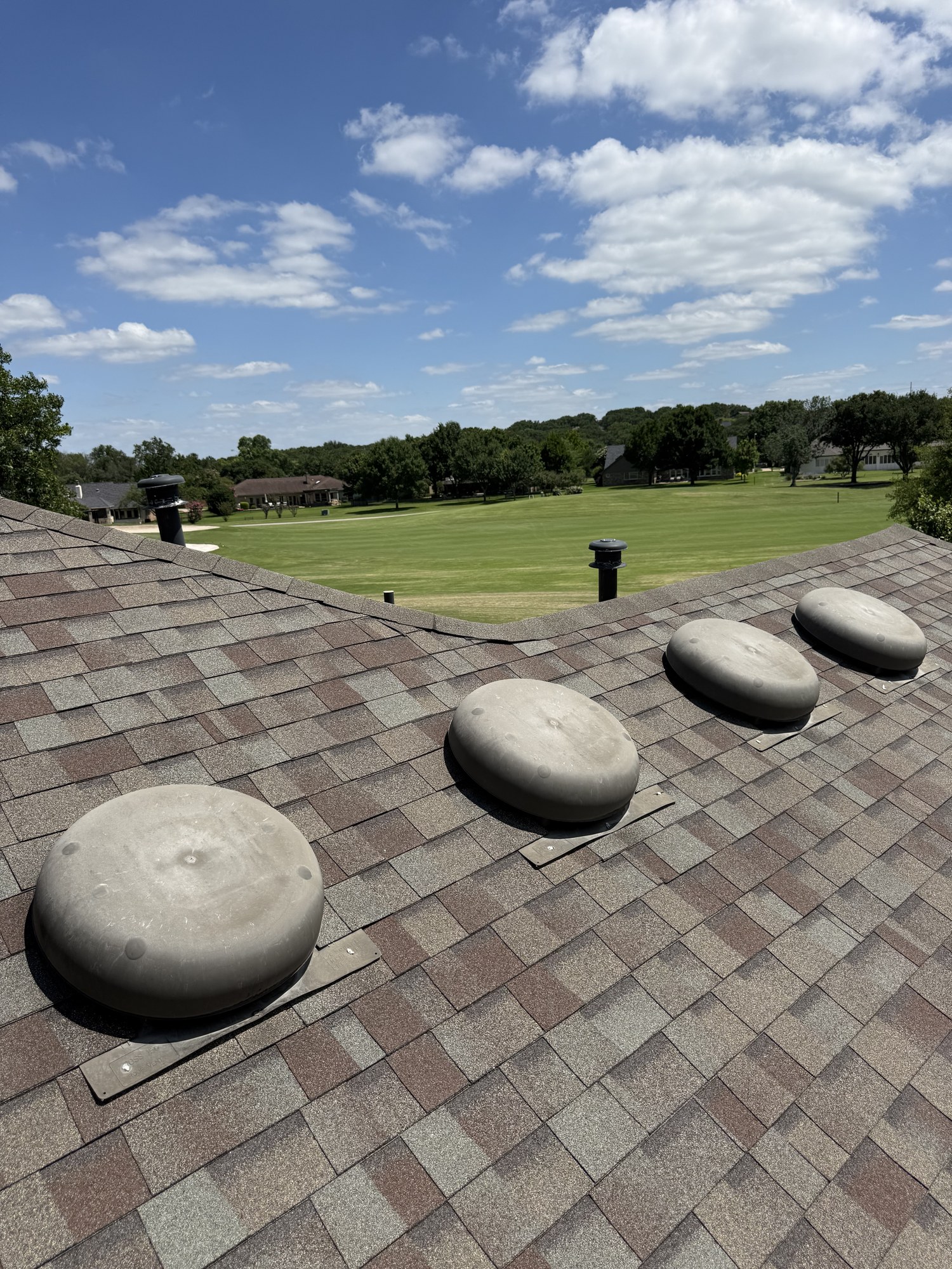 New architectural shingles with attic exhaust vents installed by Guardian Ridge Roofing