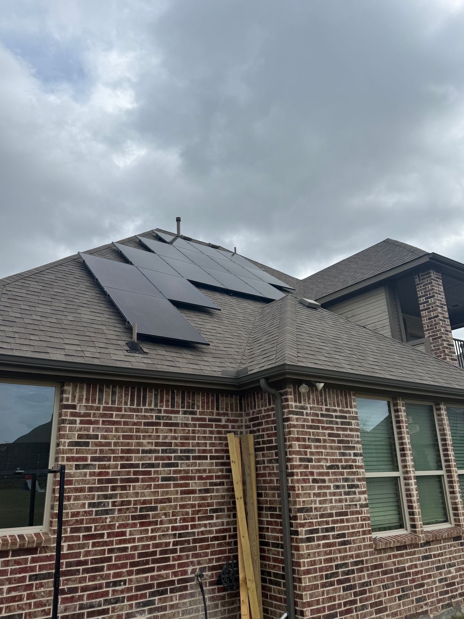 Solar panel array installed on brick residential home